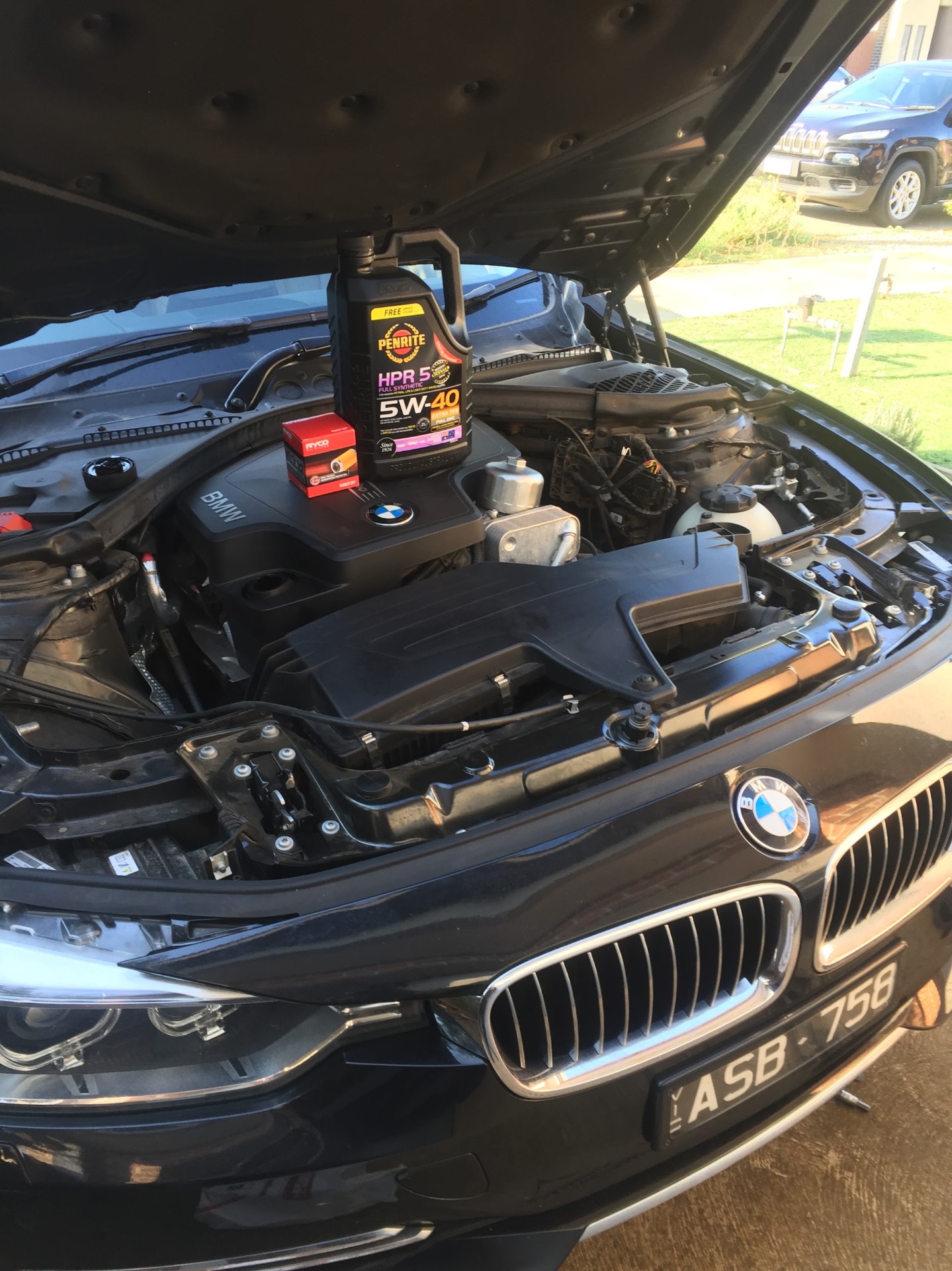 Jacob from JLE Mobile Mechanical servicing a BMW with Penrite oil and Ryco filter on-site